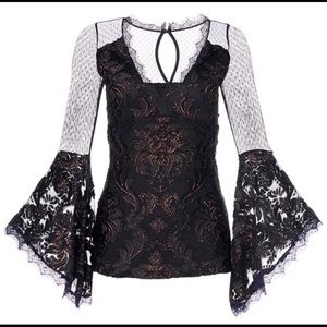 Beautiful fitted lace top with bell sleeves.